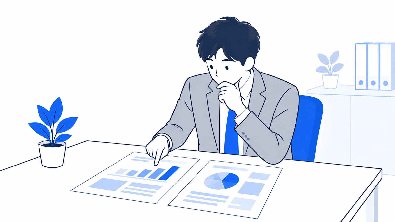 机で2つの資料を見比べながら考える担当者