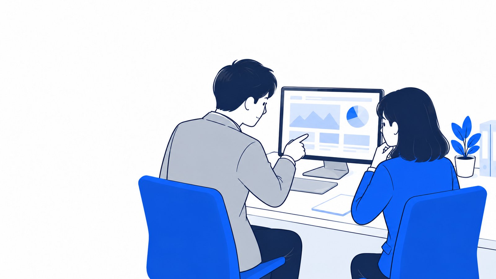 小さな事務所で、経営者と担当者が一緒にPCの画面を見て相談している