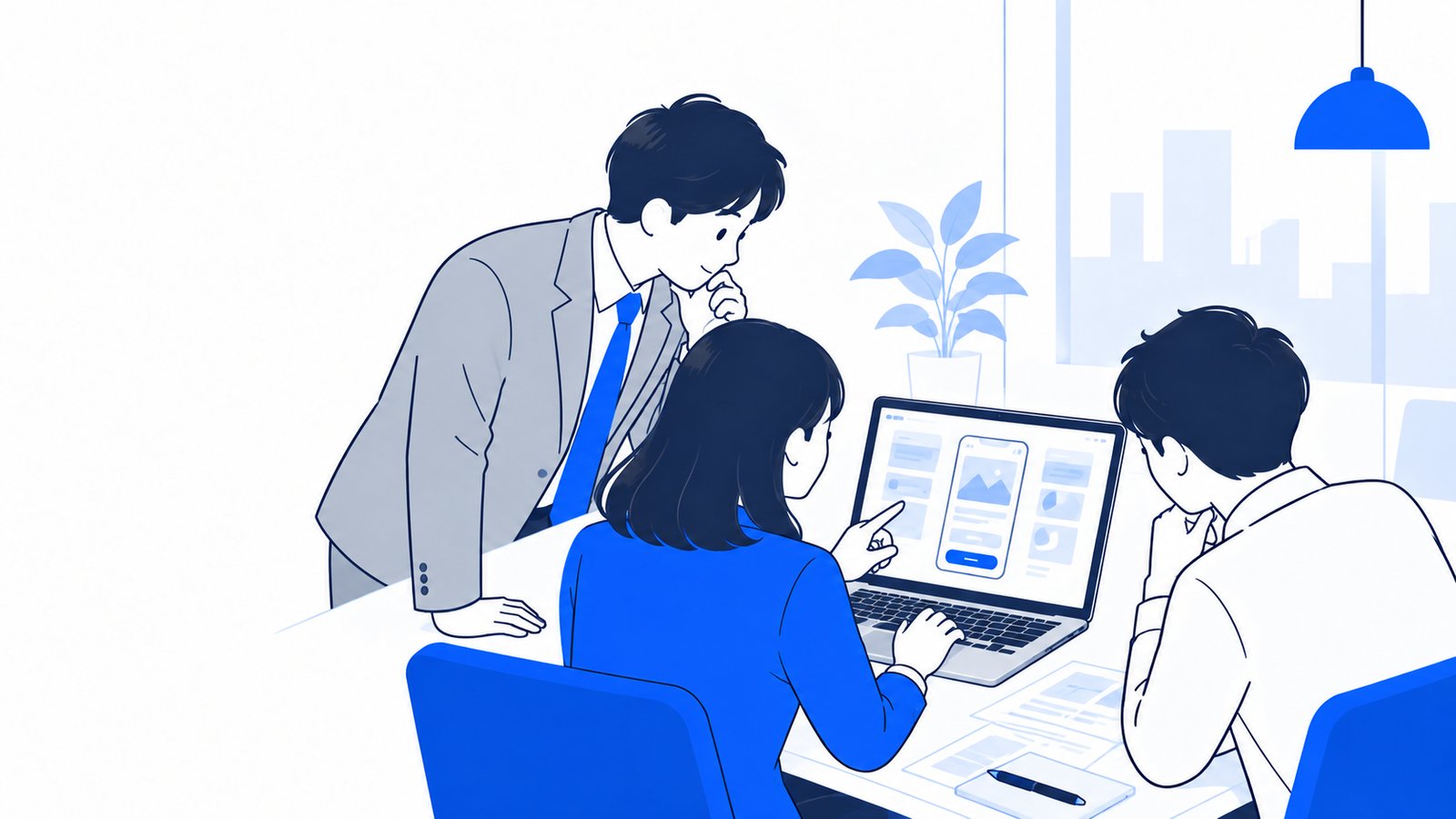 ノートPCの画面を見ながら、作りたいアプリの画面案を同僚と相談する会社員