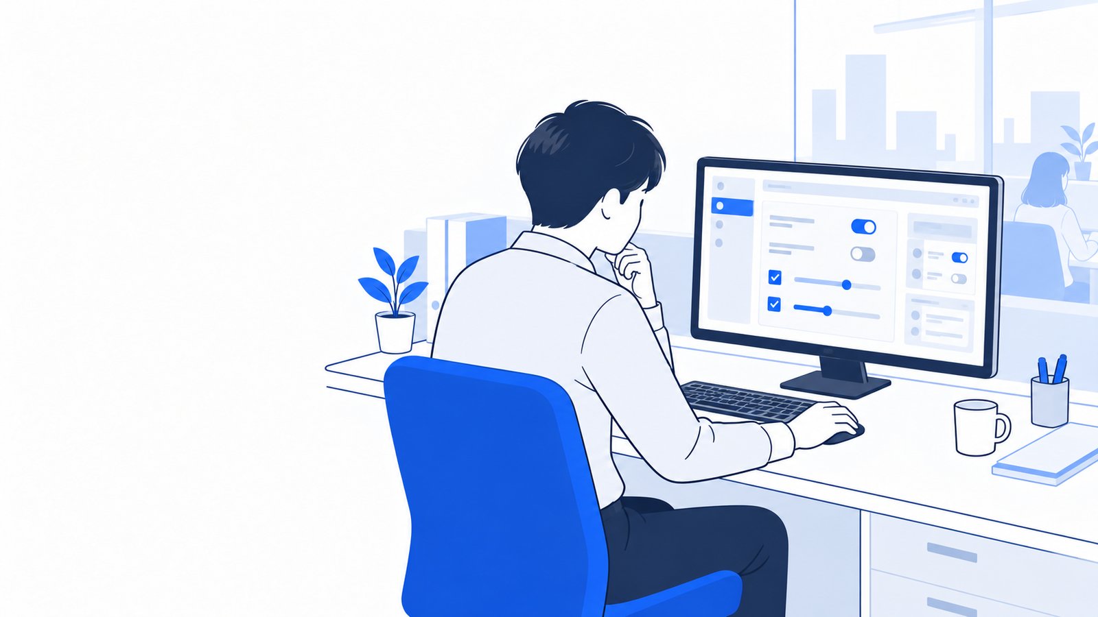 情報システム担当がPCで設定を確認しながら考えている