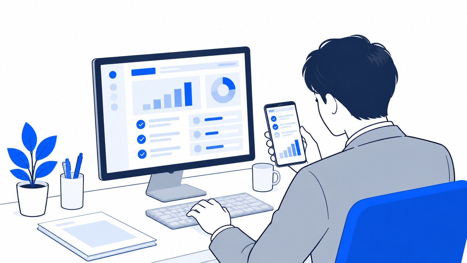 デスクトップアプリとスマホを並べて、作業の進み具合を確認している会社員