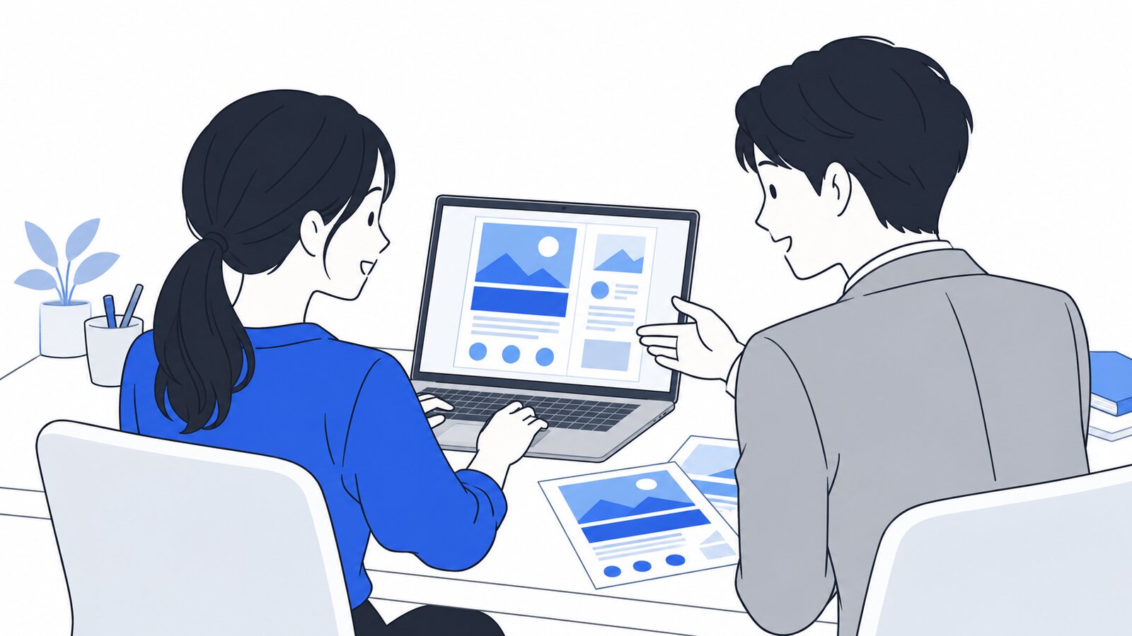 ノートPCの画面に向かい、会話しながらチラシの案を作っている会社員