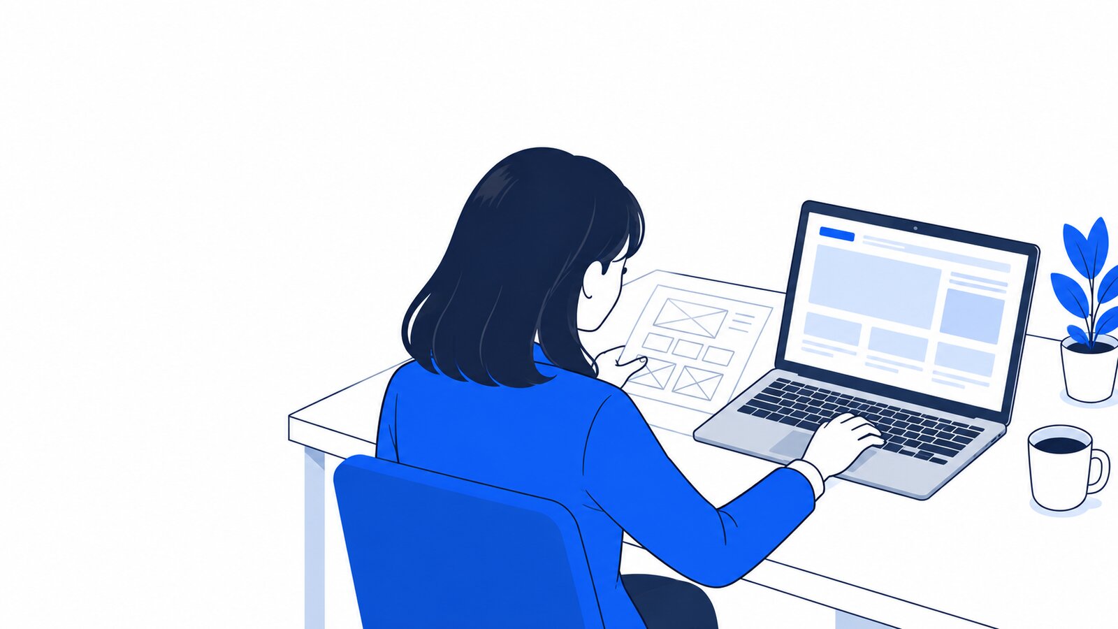 机で、紙の手書きラフを見ながらPCに指示を書き込んでいる担当者