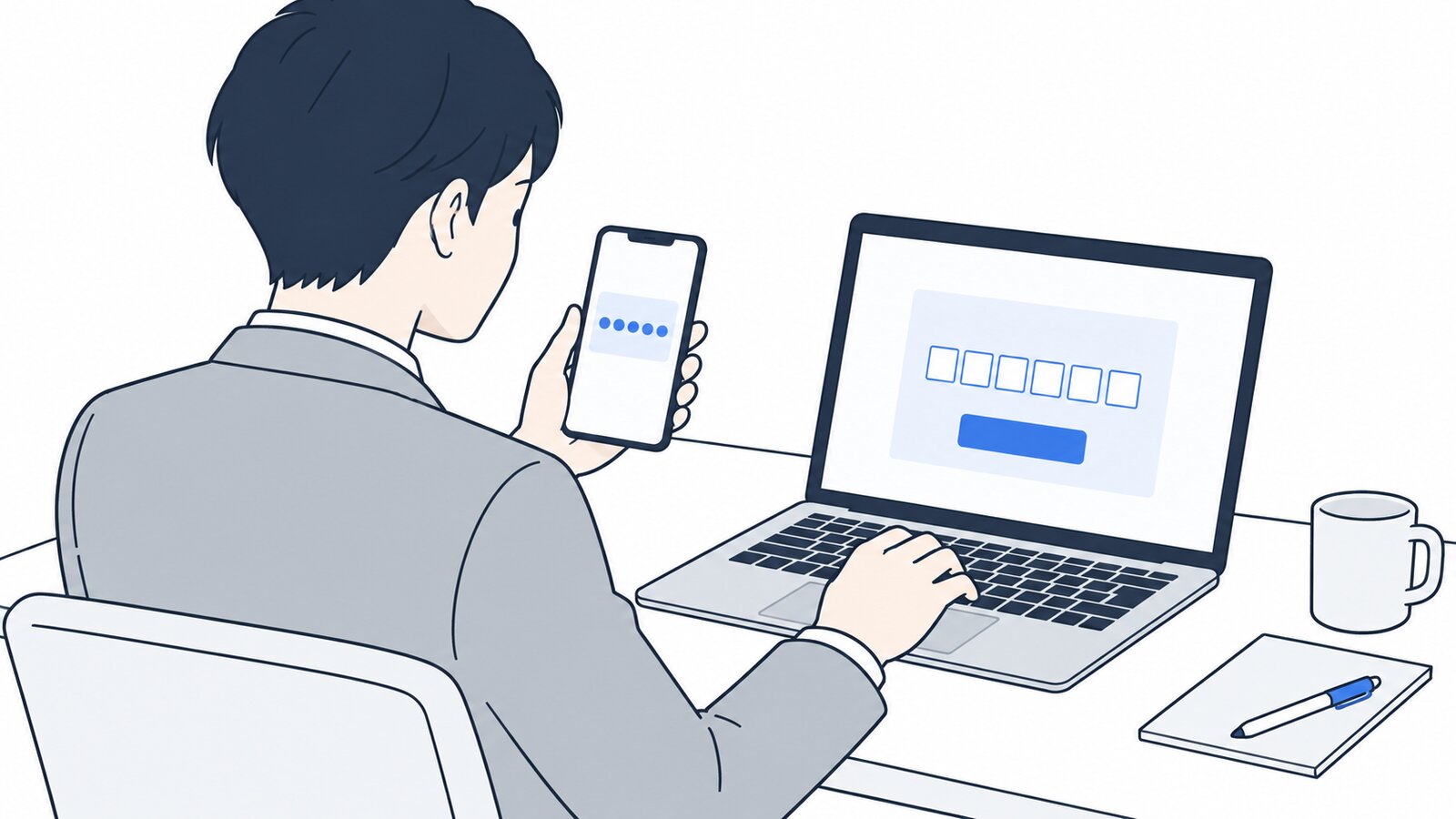 スマホに届いた確認コードをパソコンに入力する会社員
