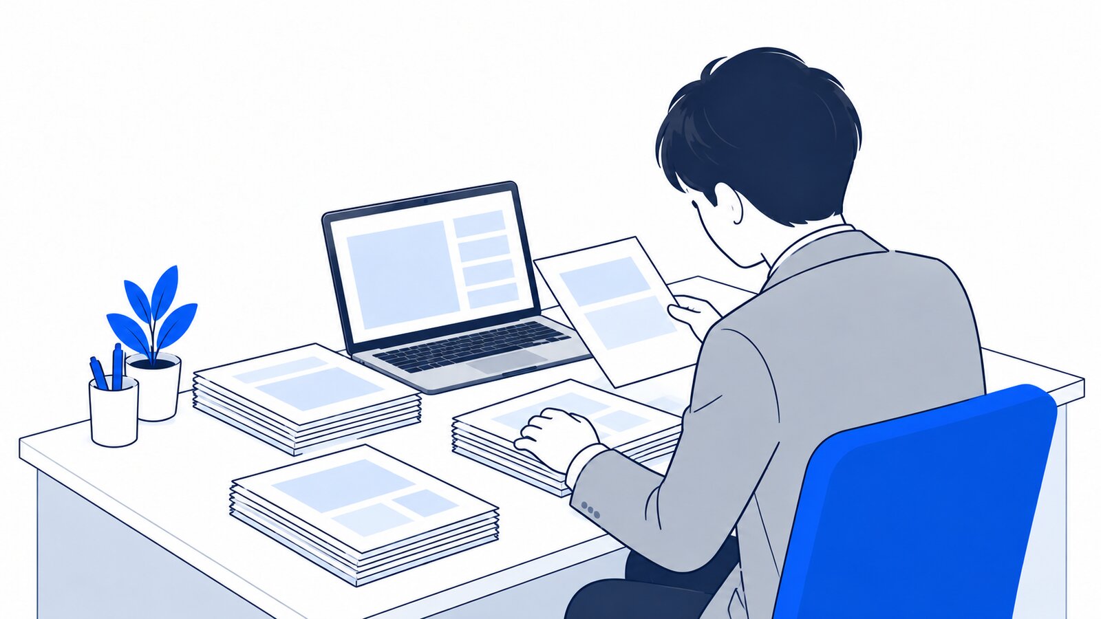 机の上で書類をいくつかの山に分けて整理する担当者とノートPC