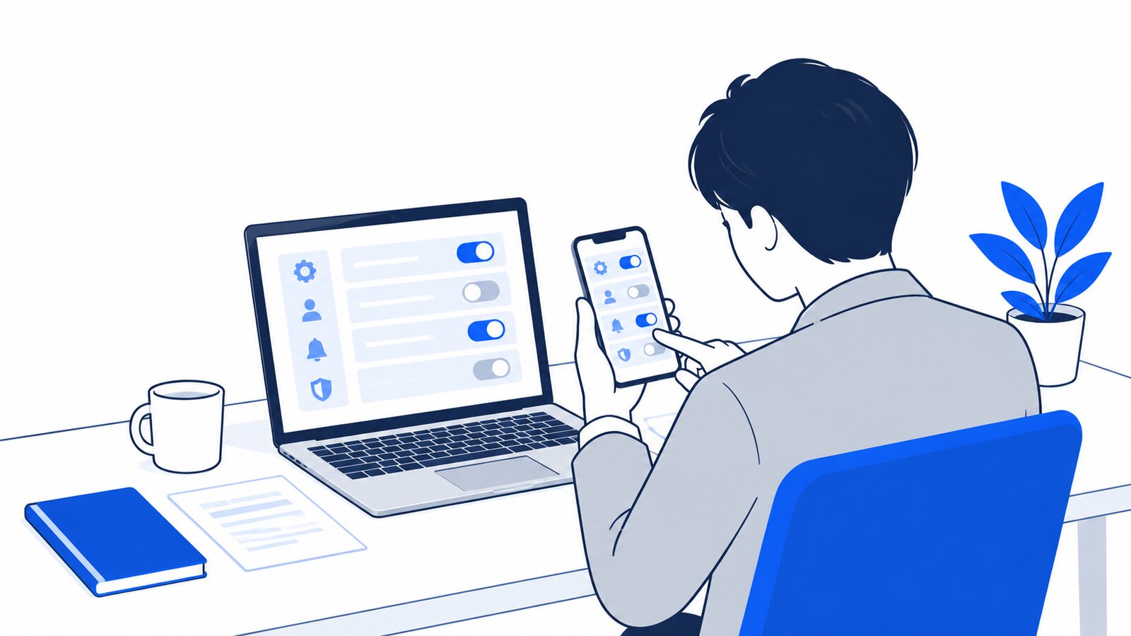 パソコンとスマホで設定画面を開いて見比べる会社員