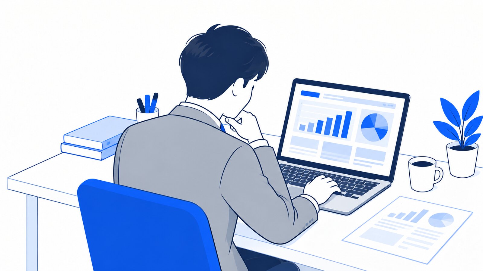 自席でノートPCに表示したグラフ入りの報告書を確認する担当者