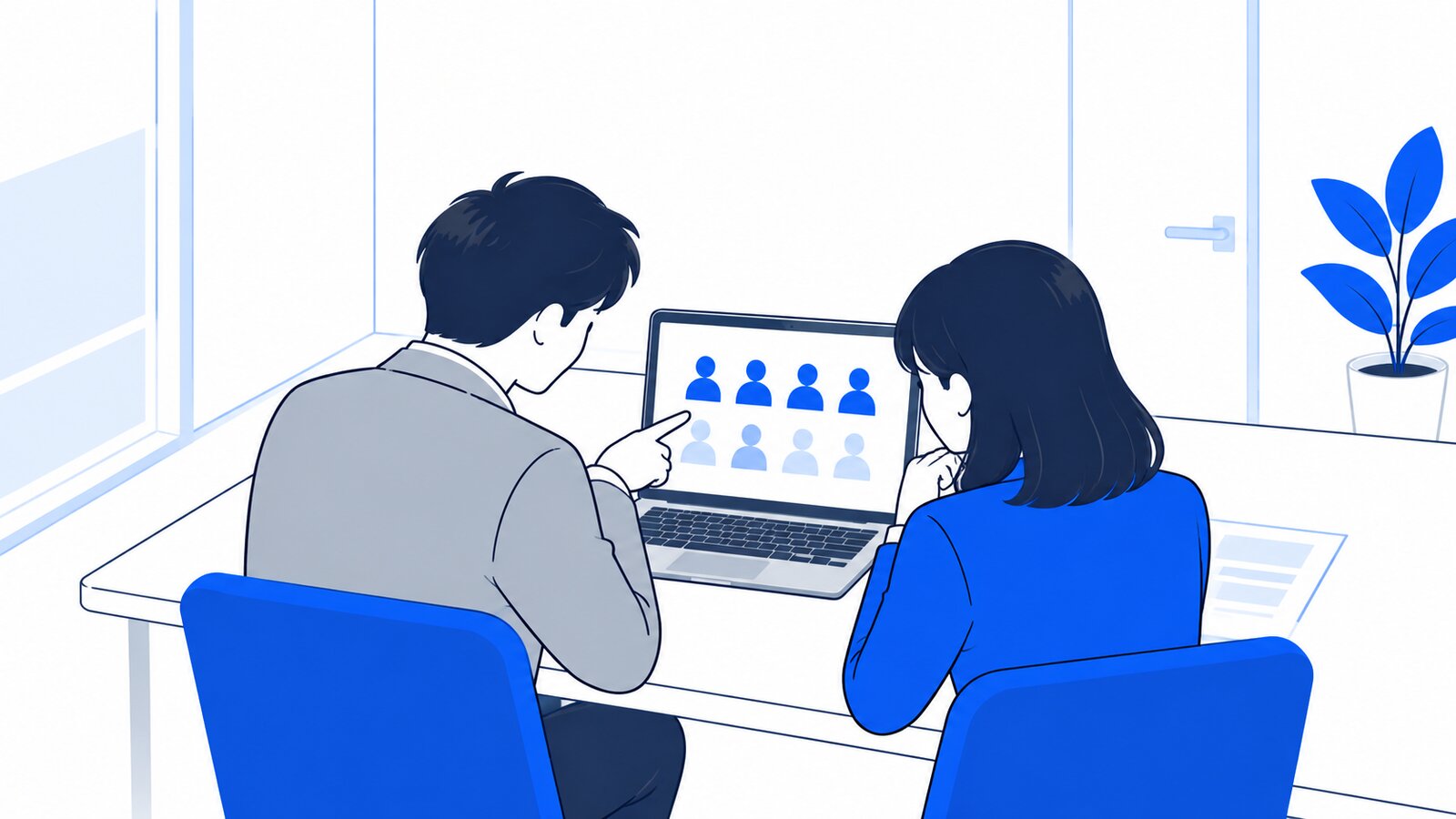 小さな会議室で、ノートPCを見ながら導入人数を相談する二人。画面は二人の方を向いている
