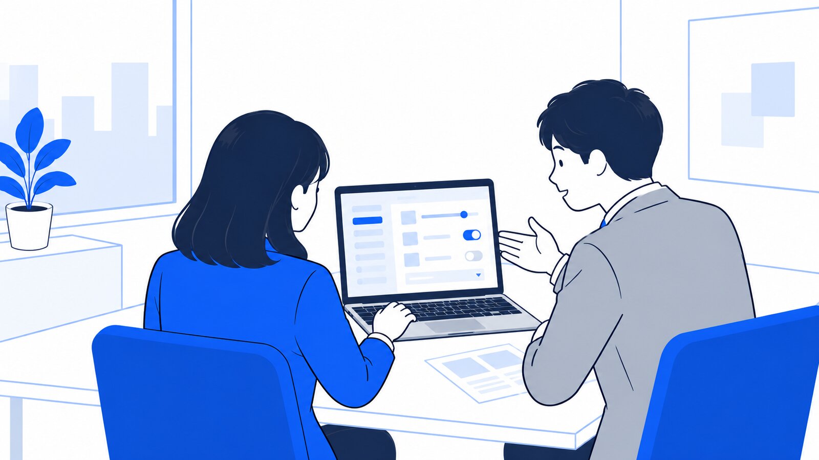 会議室で担当者がPCの設定画面を確認しながら、上司と話している様子