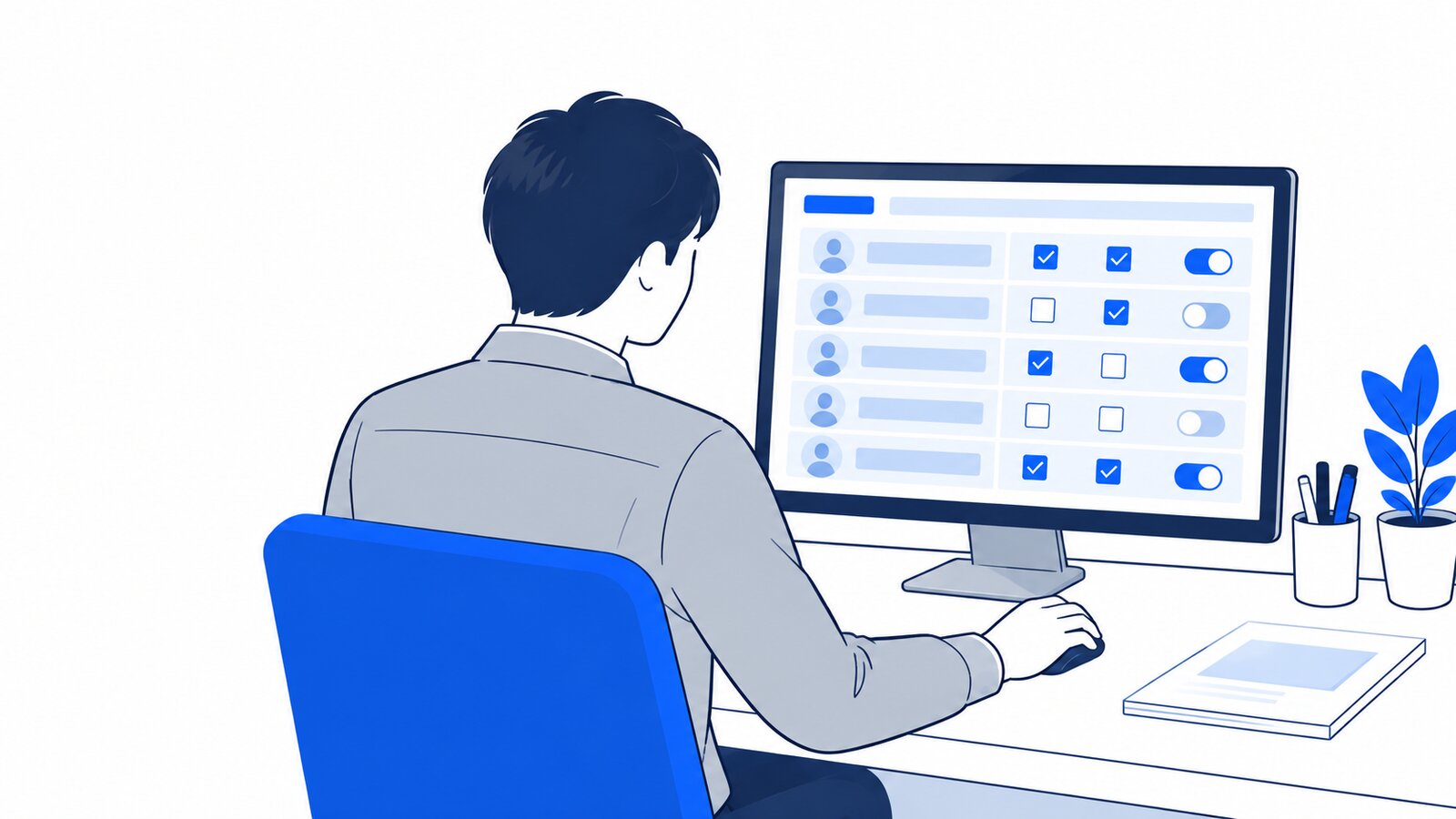 情報システム担当がパソコンで権限の設定画面を確認している