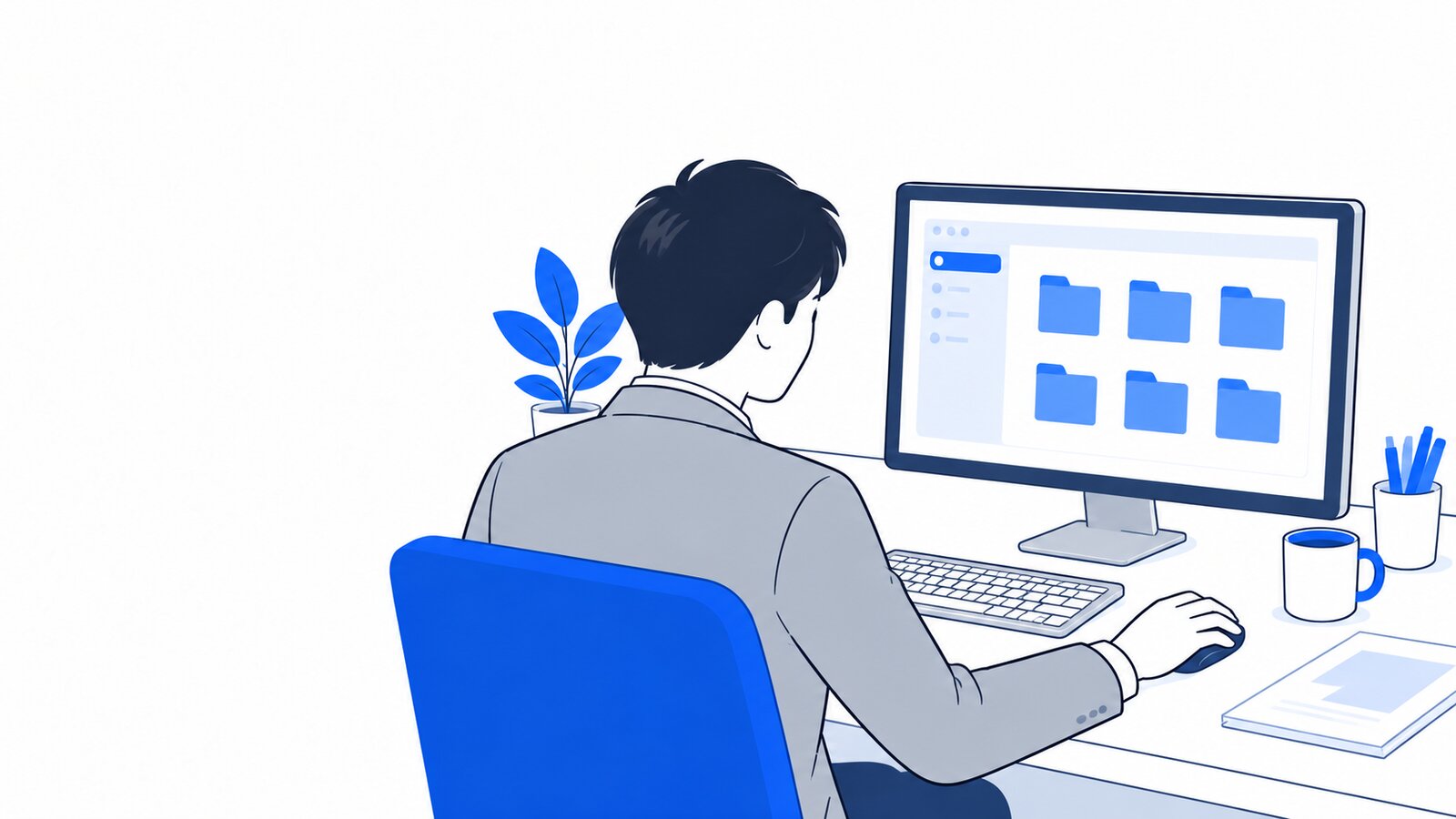 机の上でパソコンの中のフォルダを整理している会社員