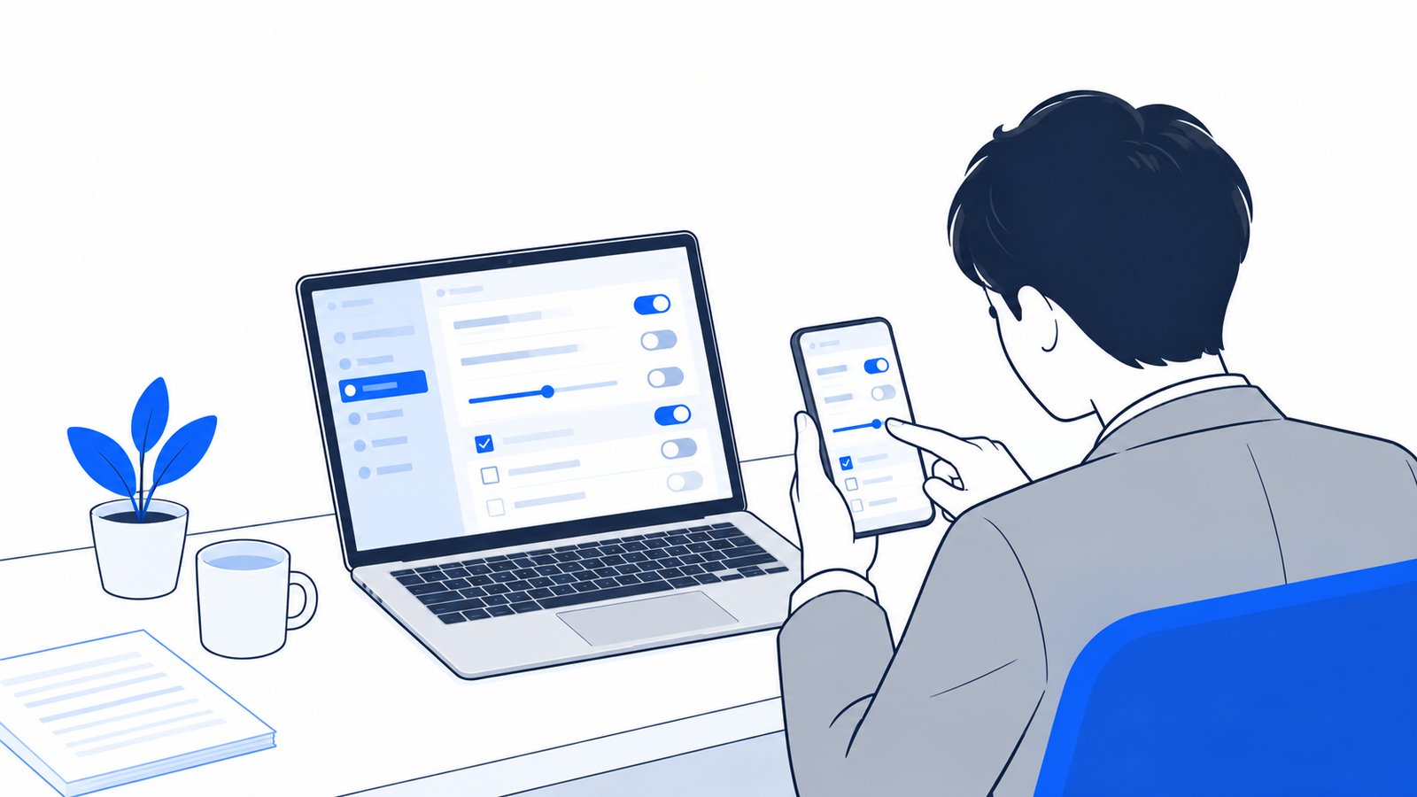 パソコンとスマホで設定画面を開いて見比べる会社員