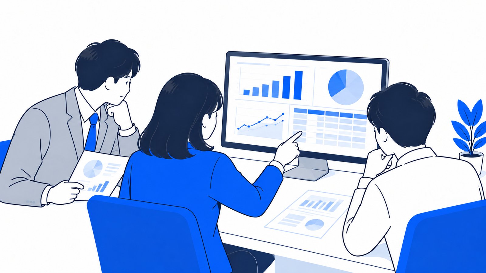 表とグラフの成果物を画面で確認している会社員
