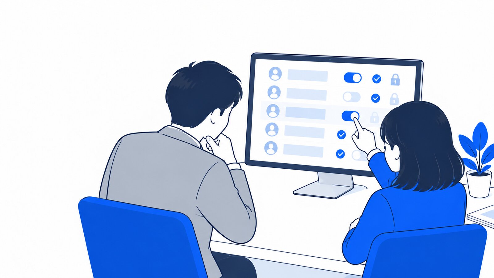 情報システム担当が上司と並んで権限設定の画面を確認している