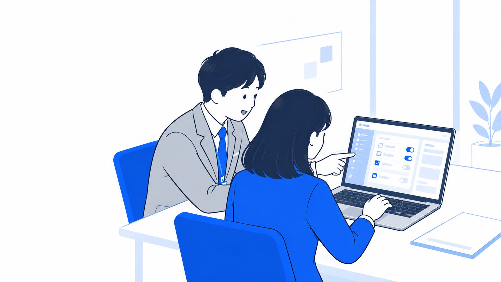 会議室でノートPCの設定画面を確かめながら情報システムの担当者と話す会社員