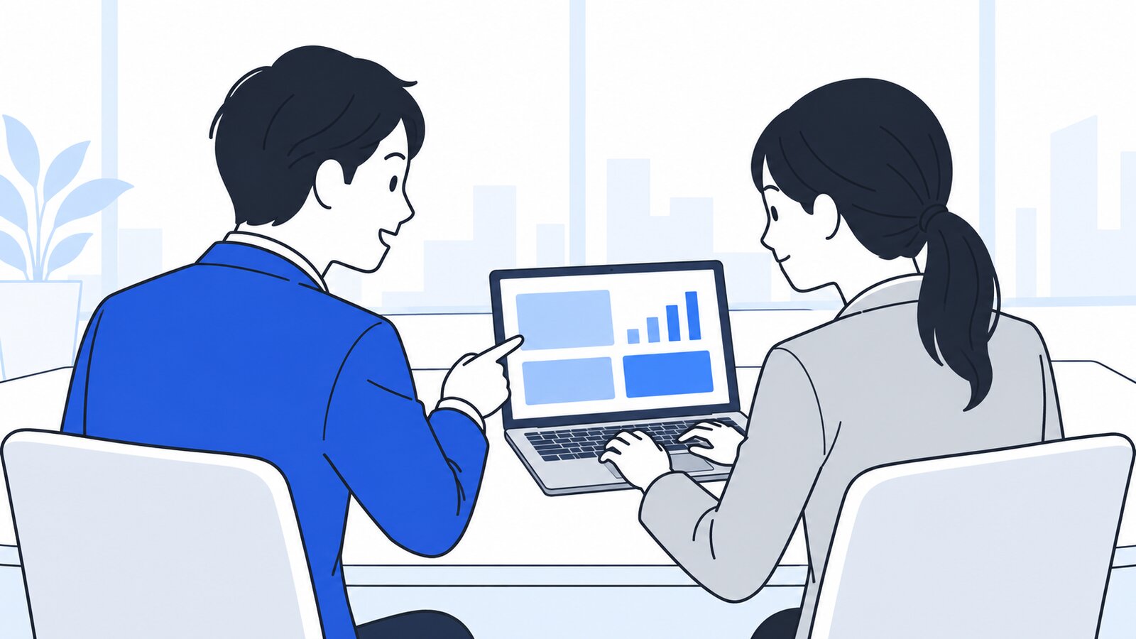 会議室で、ノートPCの画面を同僚と一緒に確認する二人