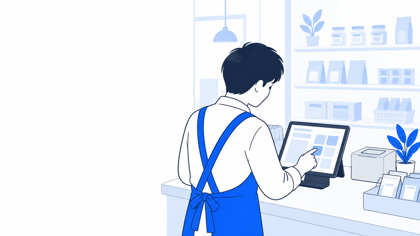 小さな店舗のカウンターでタブレットを操作する店主