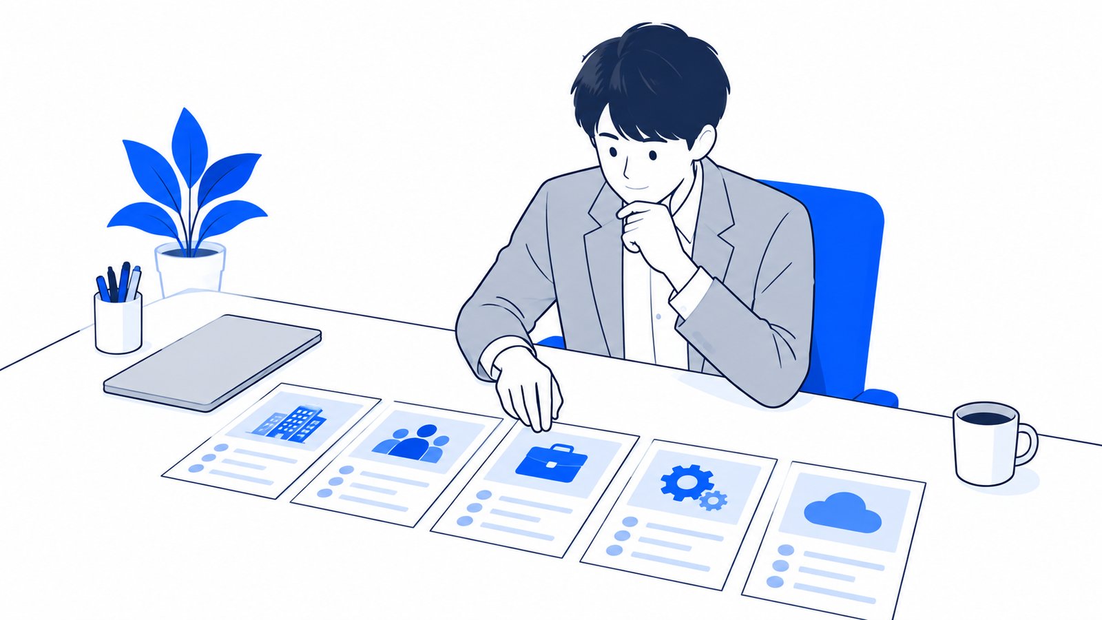 机の上に頼み先の種類ごとのカードを並べて比べている担当者